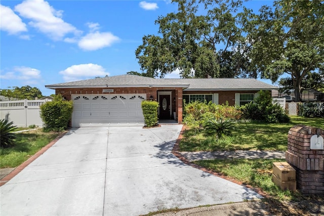 ranch-style house with a garage and a front lawn