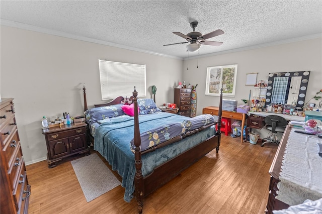 bedroom featuring ceiling fan, light hardwood / wood-style flooring, crown molding, and a textured ceiling