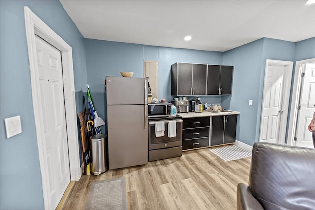 kitchen featuring light wood-type flooring and appliances with stainless steel finishes