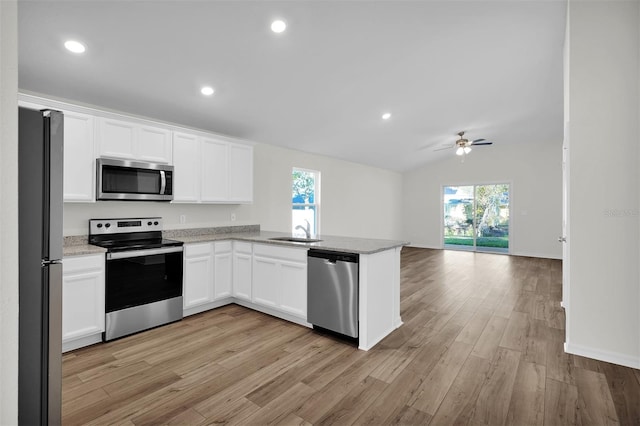 48 Prattwood Ln, Palm Coast, FL 32164 - kitchen featuring stainless steel appliances, open floor plan, light wood-style flooring, and a sink