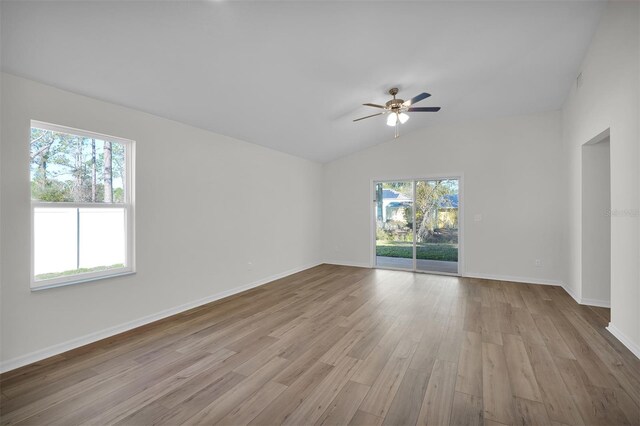 48 Prattwood Ln, Palm Coast, FL 32164 - unfurnished room featuring a wealth of natural light, vaulted ceiling, a ceiling fan, and wood finished floors