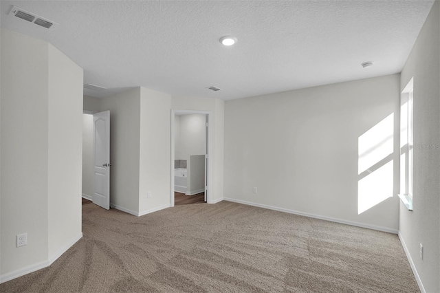 interior space featuring carpet and a textured ceiling