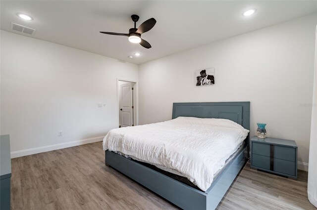 bedroom with ceiling fan and light wood-type flooring