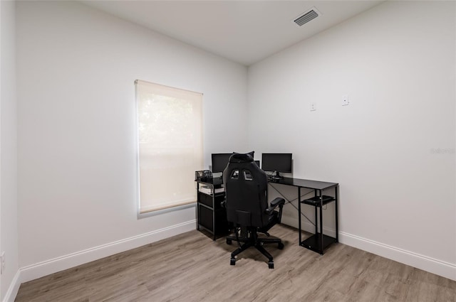 office space with light hardwood / wood-style flooring