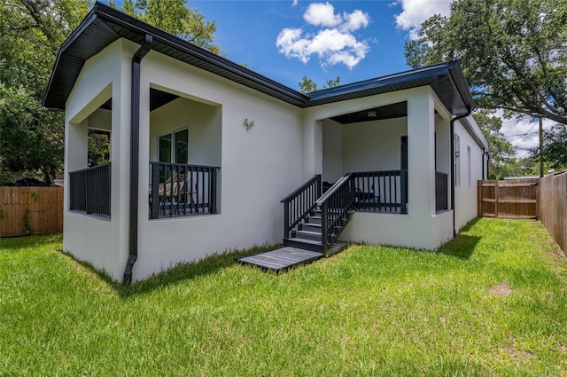 rear view of house with a yard