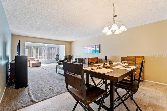 dining room featuring light tile patterned flooring, a textured ceiling, and a chandelier