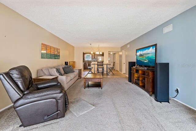 carpeted living room with a textured ceiling