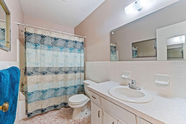 full bathroom with toilet, vanity, tile walls, tile patterned floors, and decorative backsplash