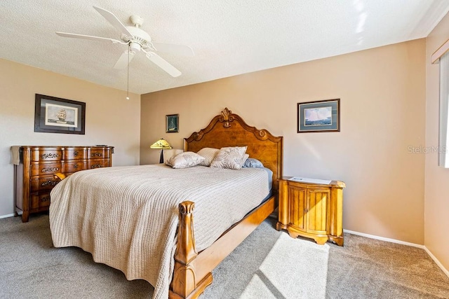 carpeted bedroom with a textured ceiling and ceiling fan