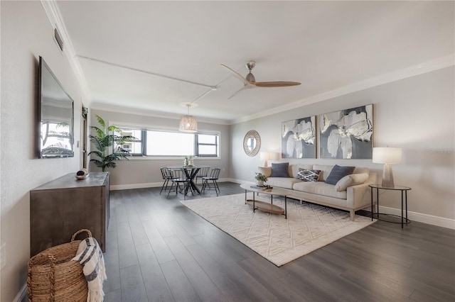 living room featuring ceiling fan, ornamental molding, and dark hardwood / wood-style floors