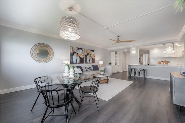 dining space with crown molding, dark hardwood / wood-style floors, and ceiling fan with notable chandelier