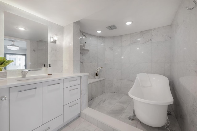 bathroom featuring vanity, tile walls, and a washtub