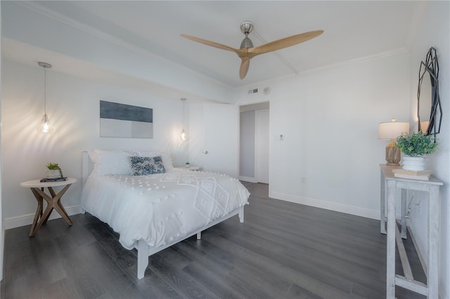 bedroom featuring ornamental molding, dark wood-type flooring, and ceiling fan