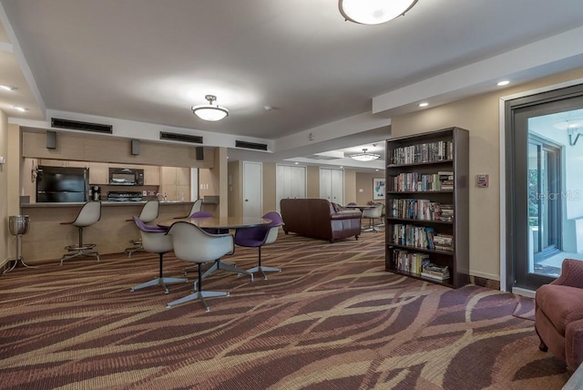 living area with dark carpet