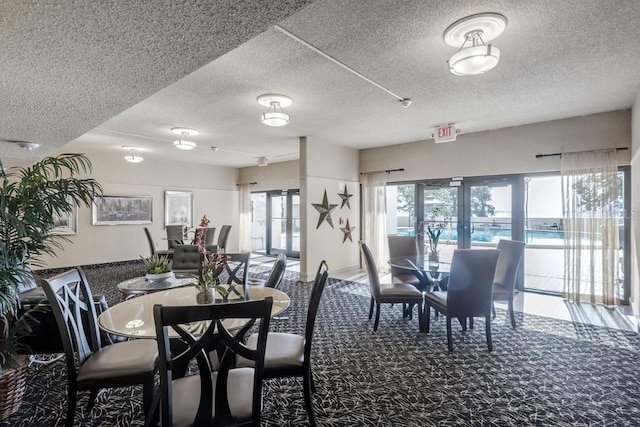 dining room featuring a textured ceiling and french doors