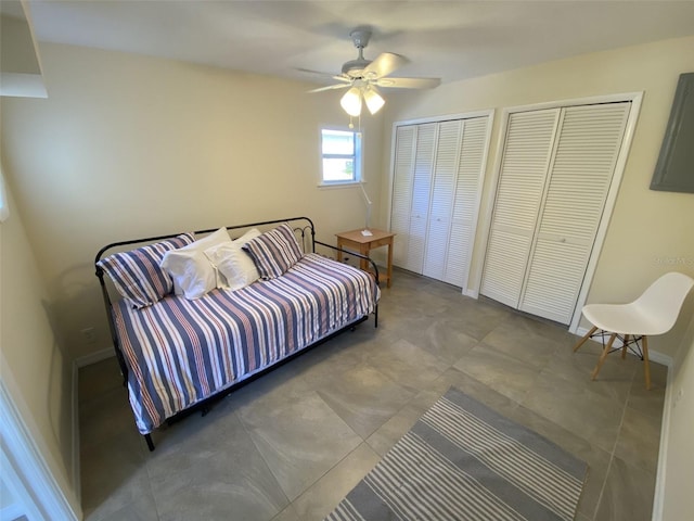 bedroom featuring two closets, ceiling fan, and tile patterned flooring