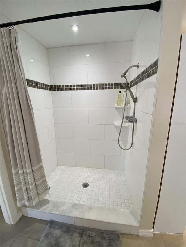 bathroom featuring tile patterned flooring and curtained shower