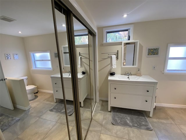 bathroom with tile patterned floors, toilet, and vanity