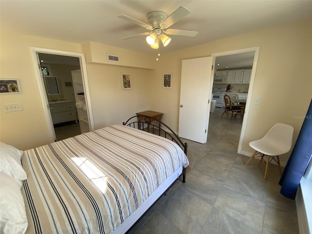 bedroom with tile patterned flooring, ceiling fan, and connected bathroom