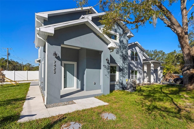 rear view of property with a yard