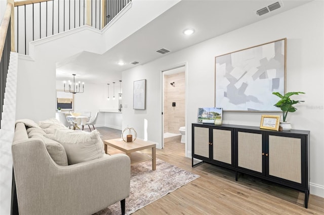 living room with hardwood / wood-style flooring and an inviting chandelier