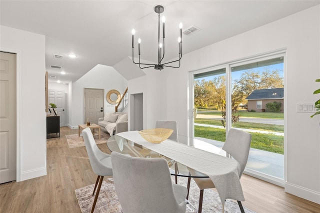 dining room featuring light hardwood / wood-style floors and a chandelier