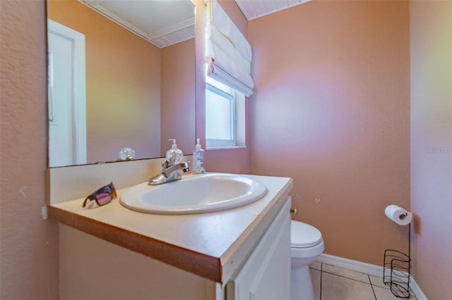 bathroom with tile patterned flooring, toilet, vanity, and baseboards