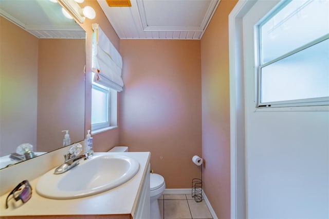 half bathroom with tile patterned floors, toilet, vanity, and baseboards