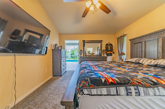 carpeted bedroom with access to exterior, vaulted ceiling, baseboards, and ceiling fan