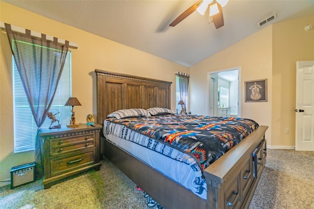 carpeted bedroom featuring lofted ceiling, a ceiling fan, visible vents, and baseboards