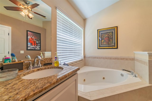 full bath featuring lofted ceiling, a ceiling fan, a jetted tub, and vanity