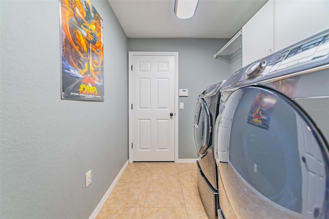 washroom with light tile patterned floors, separate washer and dryer, and baseboards