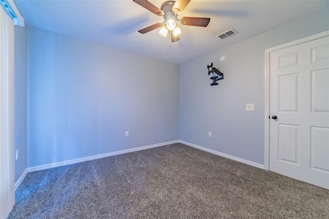 carpeted spare room featuring visible vents, baseboards, and a ceiling fan