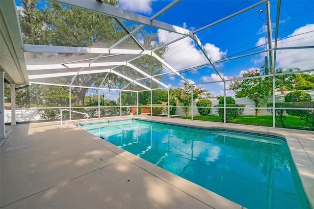 pool featuring glass enclosure and a patio