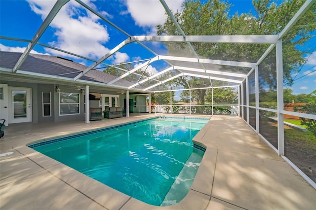 pool with glass enclosure and a patio