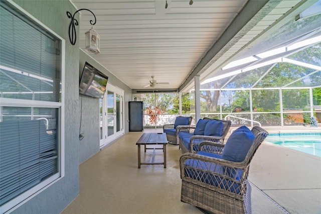 view of patio / terrace with an outdoor living space, glass enclosure, an outdoor pool, and a ceiling fan