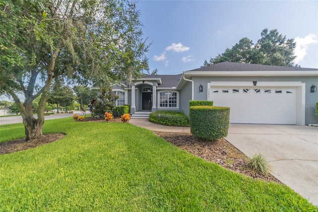 ranch-style house featuring stucco siding, driveway, an attached garage, and a front yard