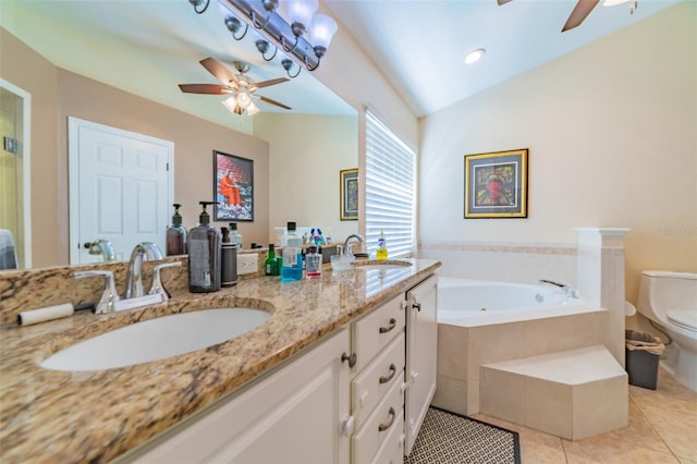 bathroom featuring tile patterned floors, toilet, a garden tub, and a sink