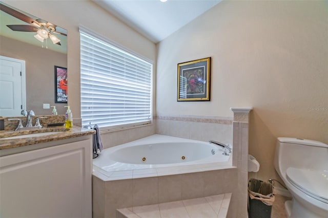 full bathroom featuring a ceiling fan, toilet, a tub with jets, and vanity