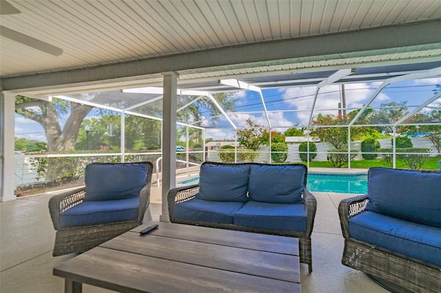 view of patio with an outdoor pool, glass enclosure, and an outdoor hangout area