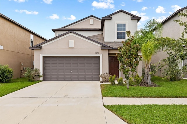 view of front of house with a garage and a front yard