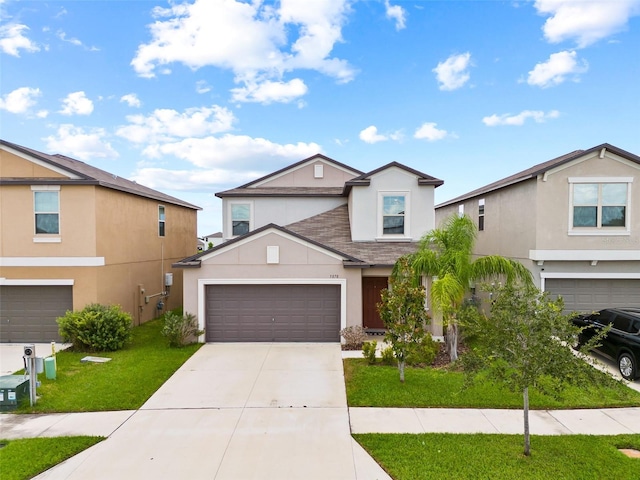 view of property featuring a garage and a front yard