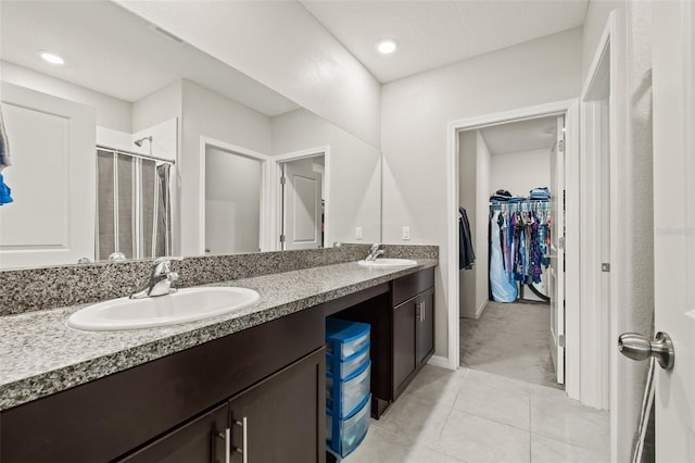 bathroom featuring tile patterned floors and dual bowl vanity