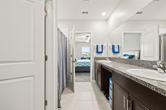 bathroom featuring dual bowl vanity, ceiling fan, and tile patterned floors