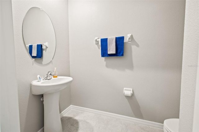 bathroom with tile patterned floors and toilet