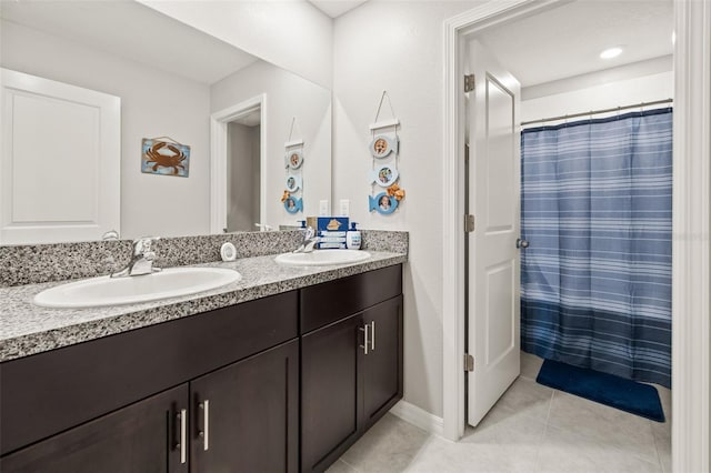 bathroom with double vanity and tile patterned floors