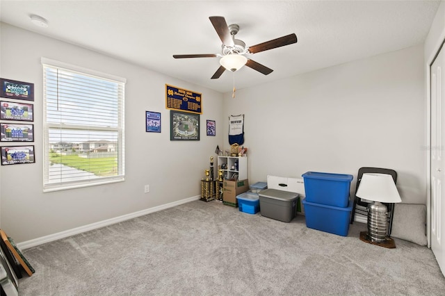 misc room with carpet flooring, a wealth of natural light, and ceiling fan