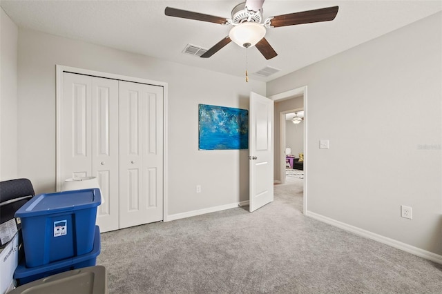 interior space featuring light colored carpet and ceiling fan