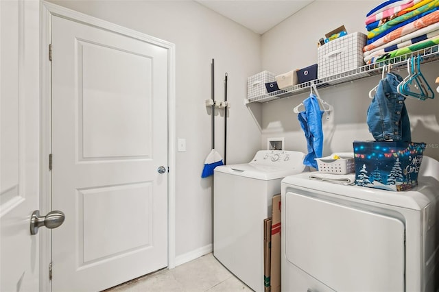 washroom with separate washer and dryer and light tile patterned floors