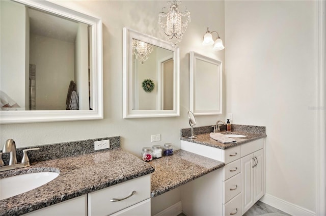 bathroom with vanity and an inviting chandelier